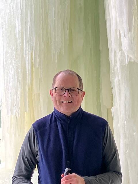 Paul Fishback near a frozen waterfall